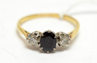 Lot 173 - A three-stone sapphire and diamond ring.