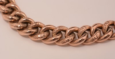 Lot 123 - A rose-coloured yellow-metal curb-link bracelet.