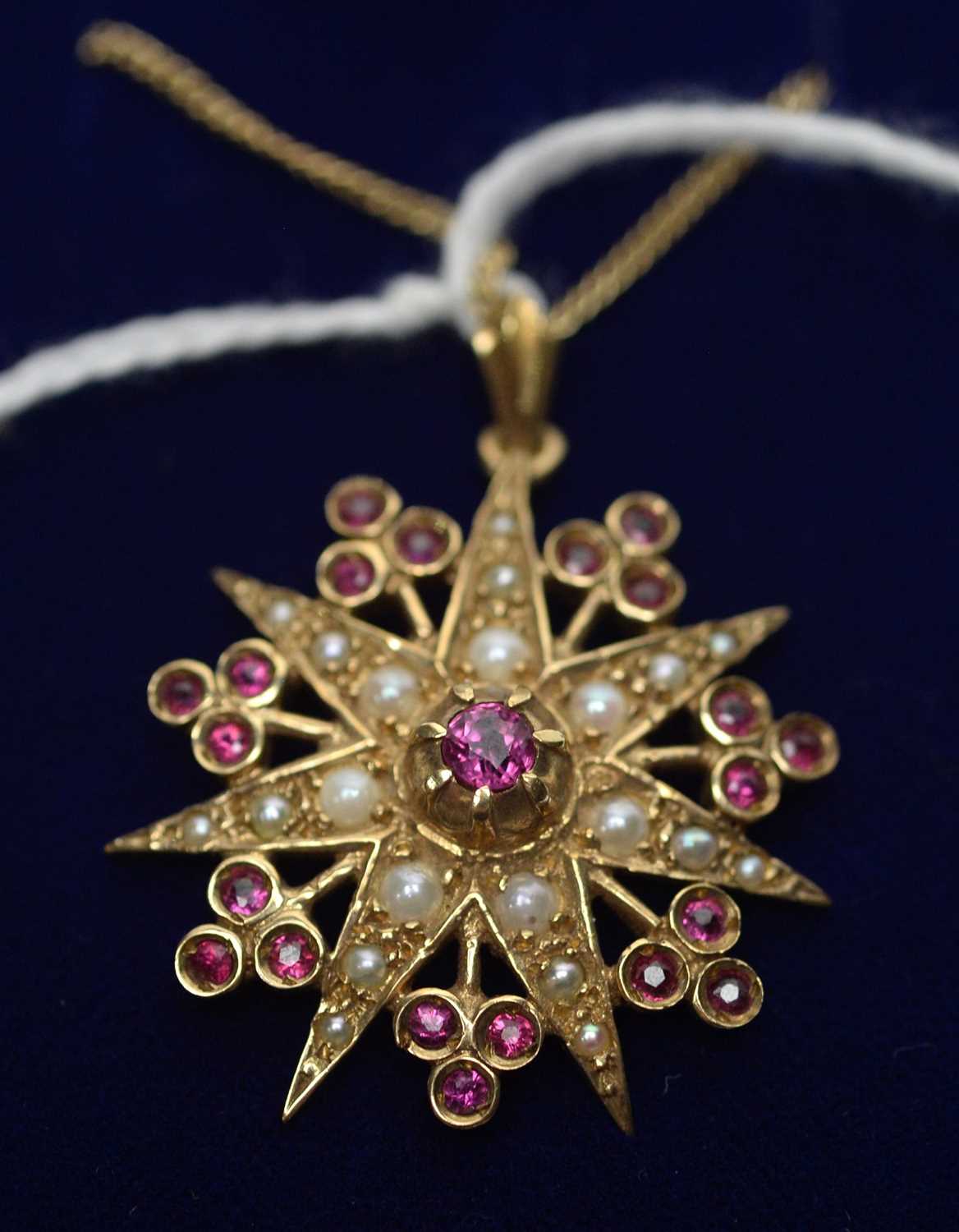 Lot 280 - A Victorian style seed pearl and ruby star shaped pendant