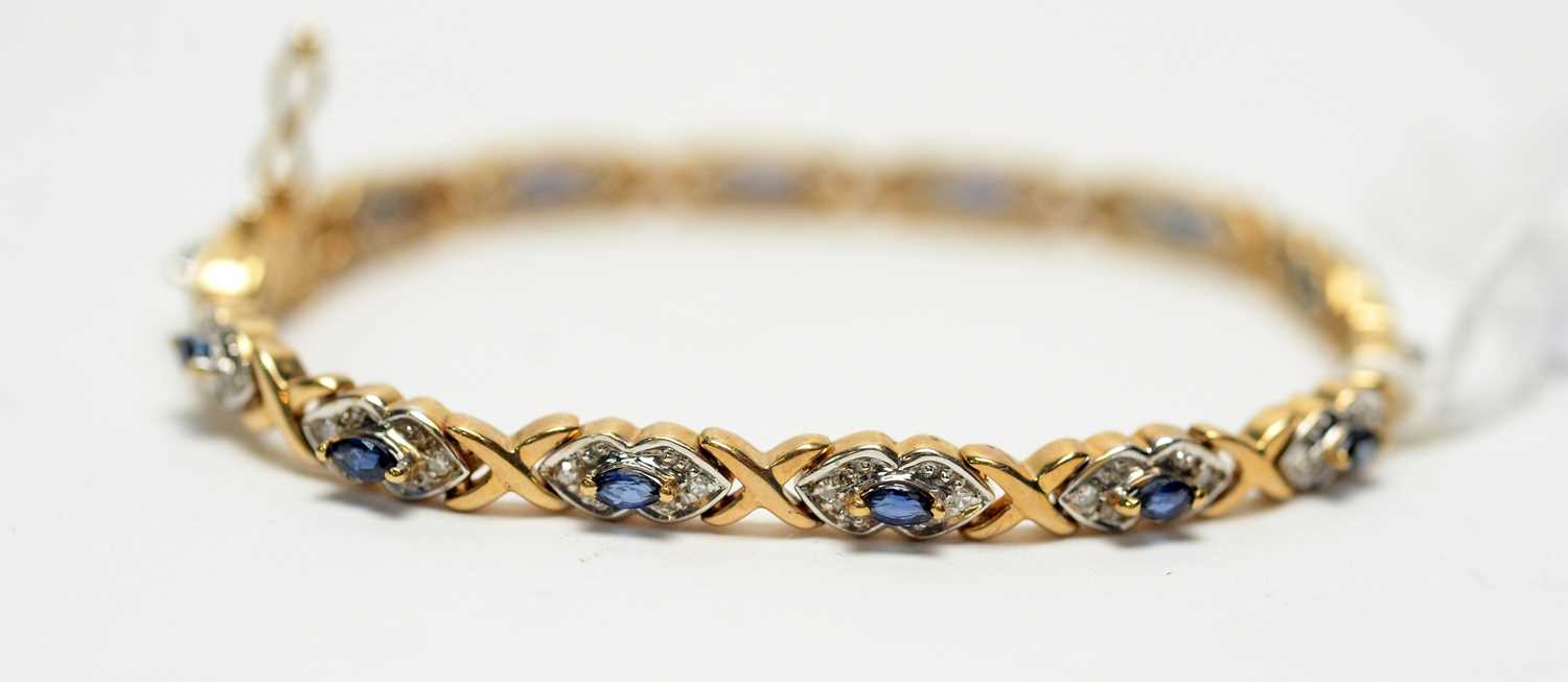 Lot 283 - A diamond and blue stone bracelet