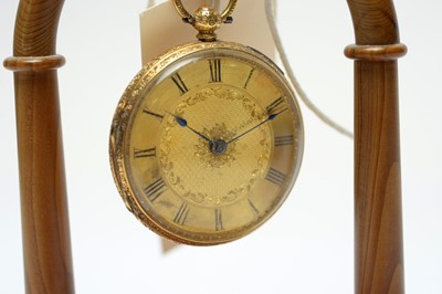 Lot 206 - An 18ct gold fob watch on a turned yew stand.