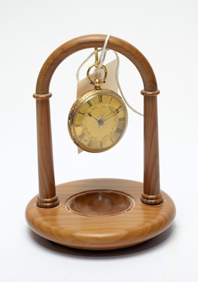 Lot 206 - An 18ct gold fob watch on a turned yew stand.