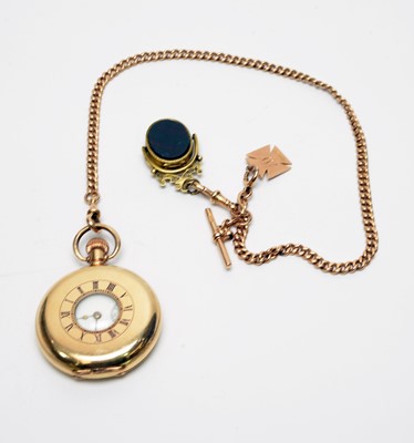 Lot 157 - A Waltham rolled-gold half-hunter pocket watch on a yellow-metal Albert watch chain.