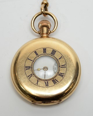 Lot 157 - A Waltham rolled-gold half-hunter pocket watch on a yellow-metal Albert watch chain.