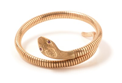 Lot 100 - A 9ct gold bangle in the form of a coiled serpent.