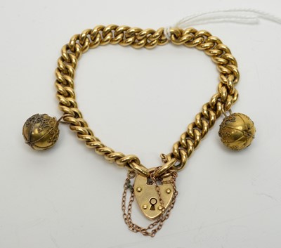 Lot 160 - A yellow-metal curb-link bracelet with bauble pendants.