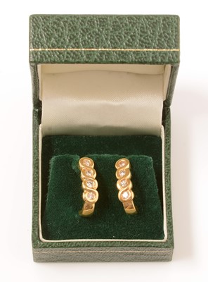 Lot 104 - A pair of diamond earrings