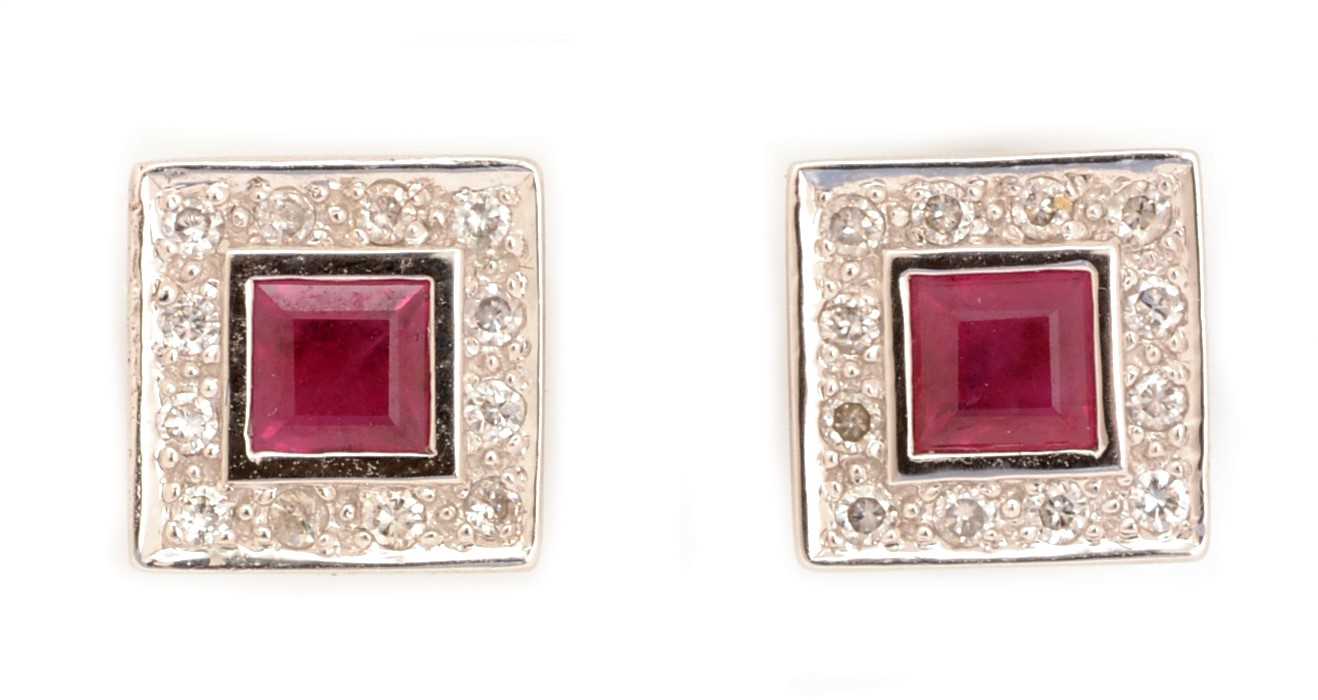 Lot 111 - A pair of ruby and diamond cluster earrings