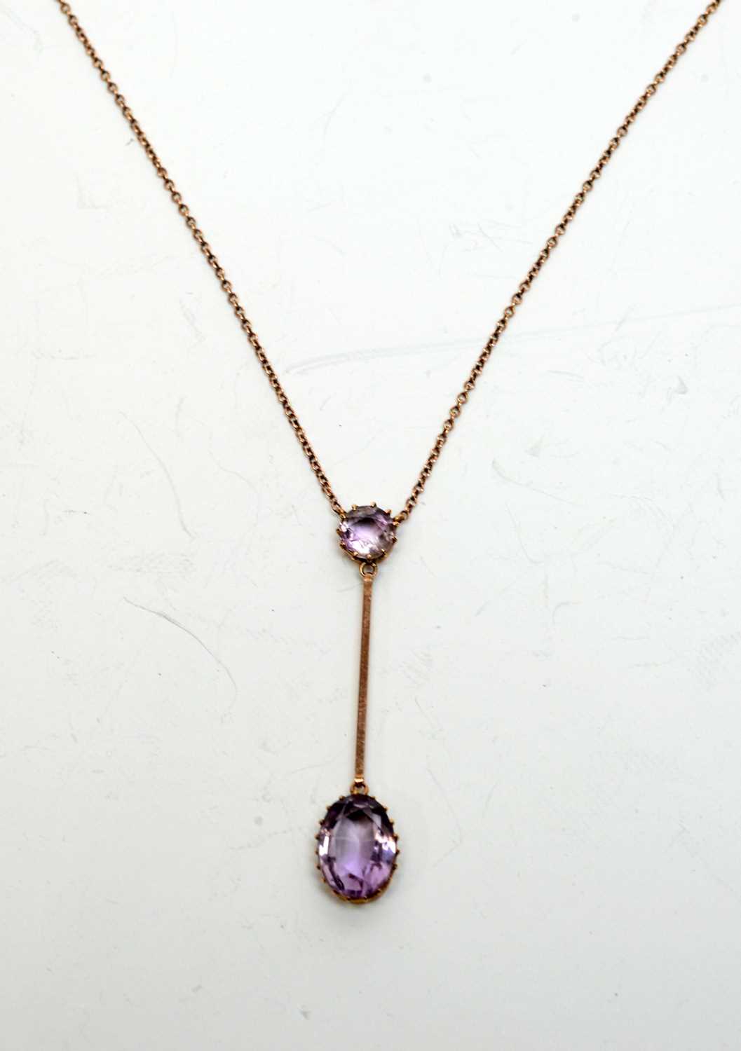 Lot 165 - An early 20th century amethyst and yellow-metal pendant.