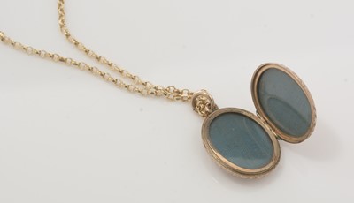 Lot 111 - A locket on a yellow metal neck chain.