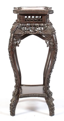 Lot 544 - A Chinese carved hardwood jardiniere stand