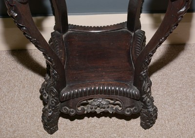 Lot 544 - A Chinese carved hardwood jardiniere stand