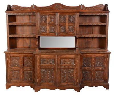 Lot 545 - An early 20th Century carved oak breakfront side cabinet