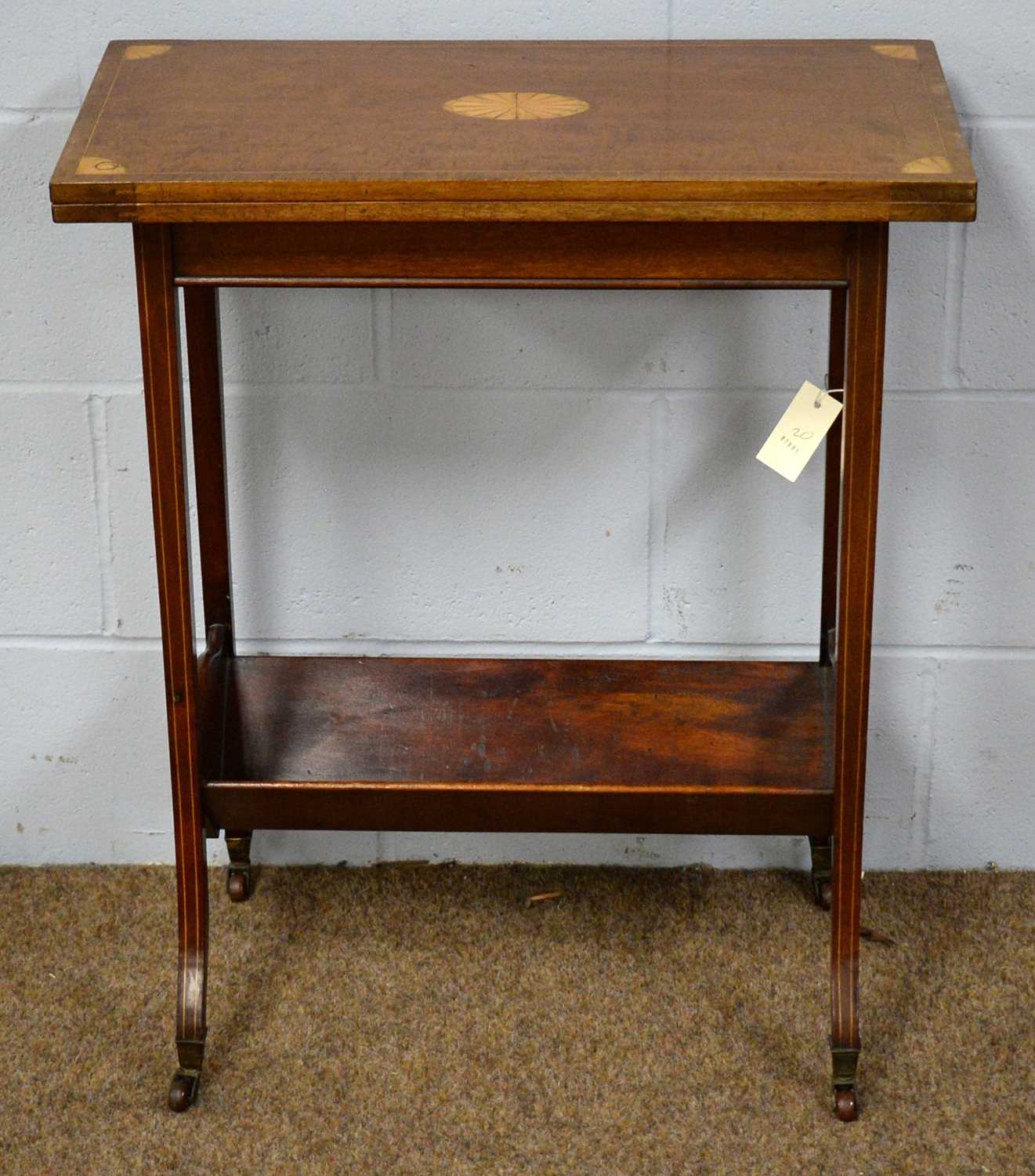 Lot 49 - An Edwardian fold-over card table of small proportions