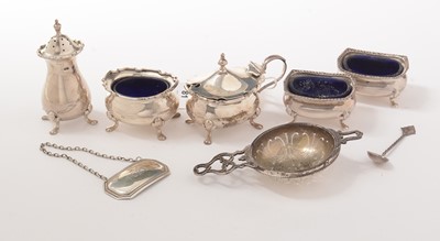 Lot 81 - Silver tablewares, including condiments, tea strainer, and bottle ticket.