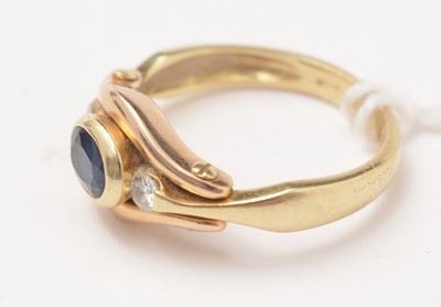 Lot 103 - A modern diamond and sapphire three-stone ring.