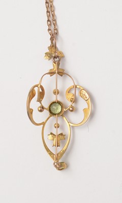 Lot 115 - An Edwardian Art Nouveau peridot and pearl pendant.