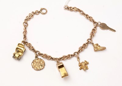 Lot 107 - A yellow-metal fancy-link charm bracelet and charms.