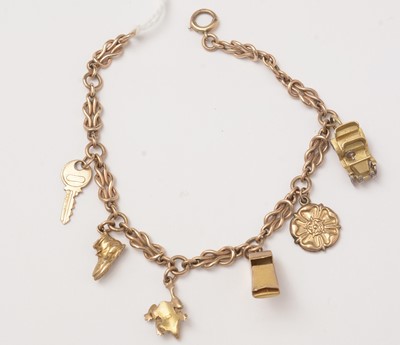 Lot 107 - A yellow-metal fancy-link charm bracelet and charms.