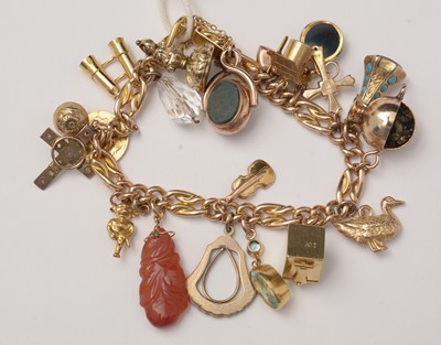 Lot 90 - A yellow-metal charm bracelet and charms.