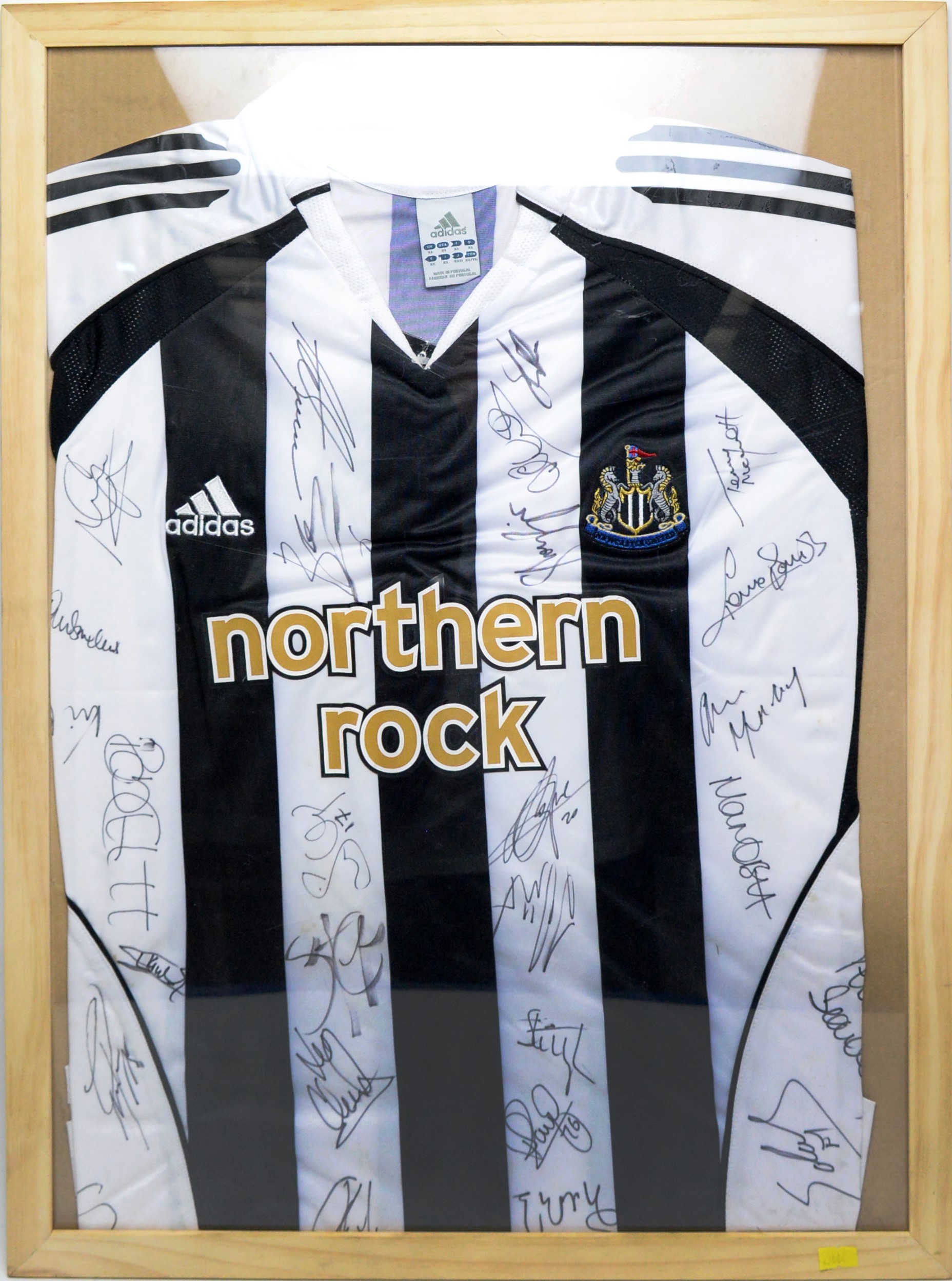 Lot 639 - A Newcastle United home shirt signed by the