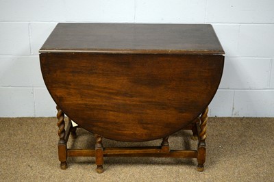 Lot 41 - 1920's stained oak drop leaf dining table.