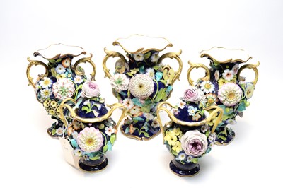 Lot 503 - Staffordshire three piece encrusted garniture and pair of covered vases