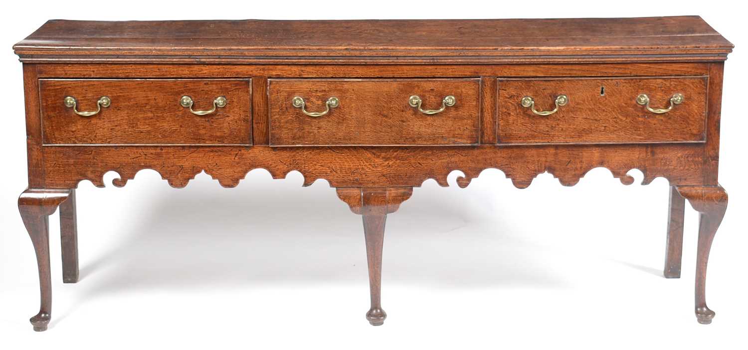 Lot 645 - George III oak low dresser.