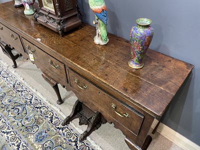 Lot 645 - George III oak low dresser.