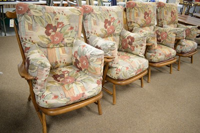 Lot 270 - Ercol: four 1914 design elm and beechwood spindle back armchairs.