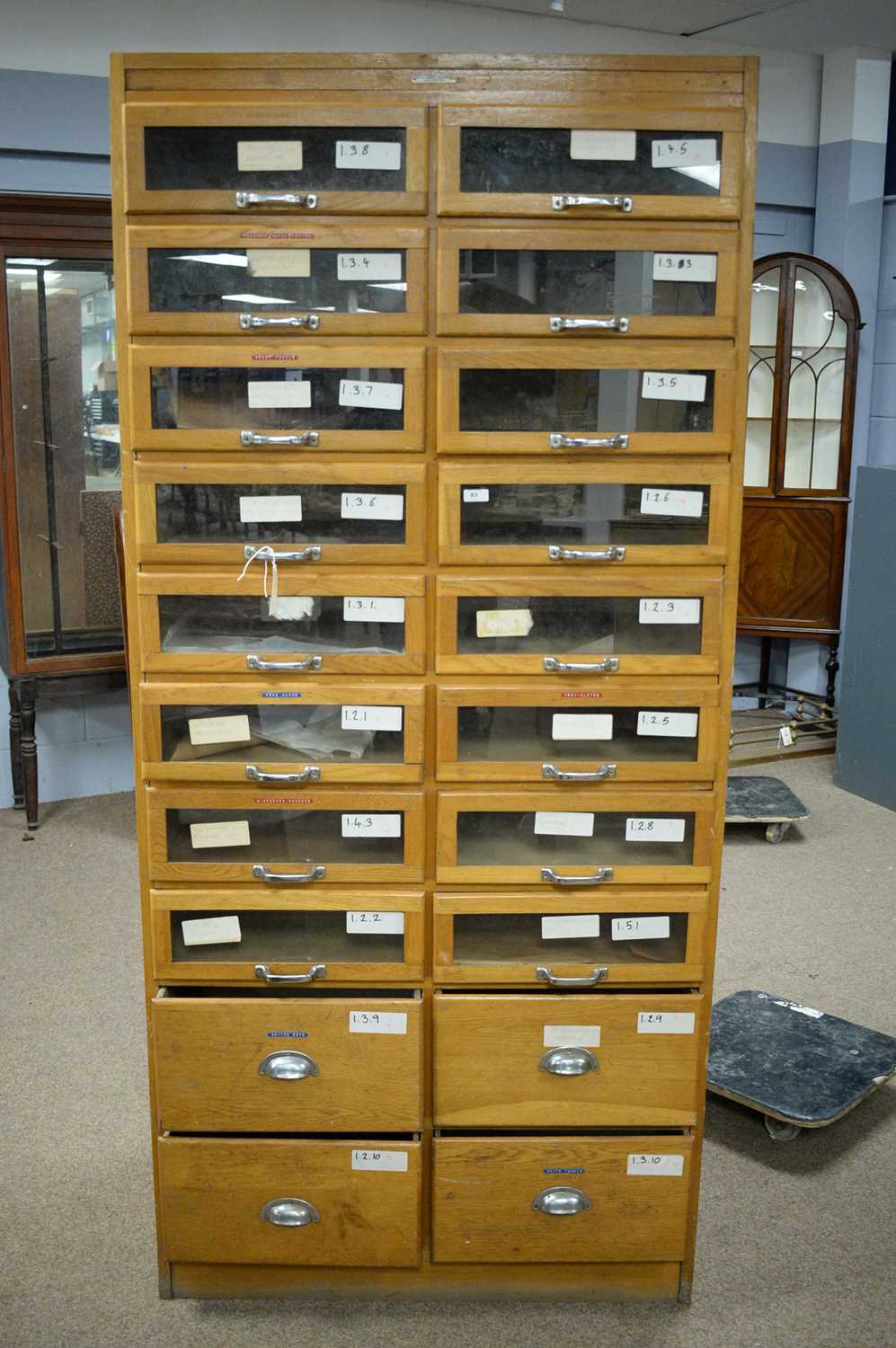 Lot 83 - A vintage light oak haberdashers cabinet