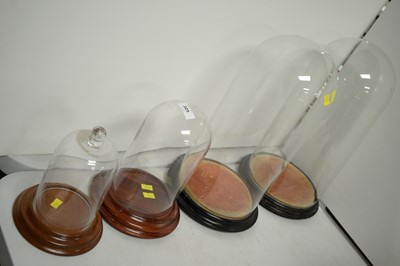 Lot 325 - Four glass domes - various.