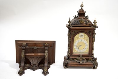 Lot 549 - A German late 19th Century carved oak quarter-chiming bracket clock.
