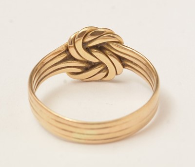 Lot 85 - A yellow-metal knot ring.