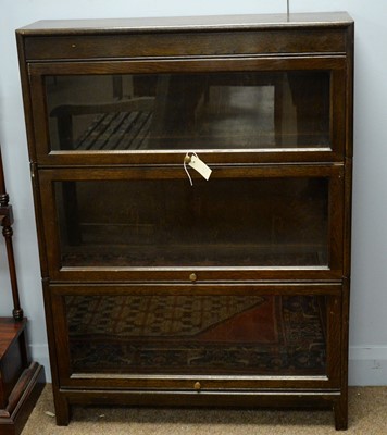 Lot 56 - An early 20th C oak sectional bookcase by Gunn.