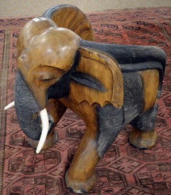 Lot 106 - An African carved elephant chair.