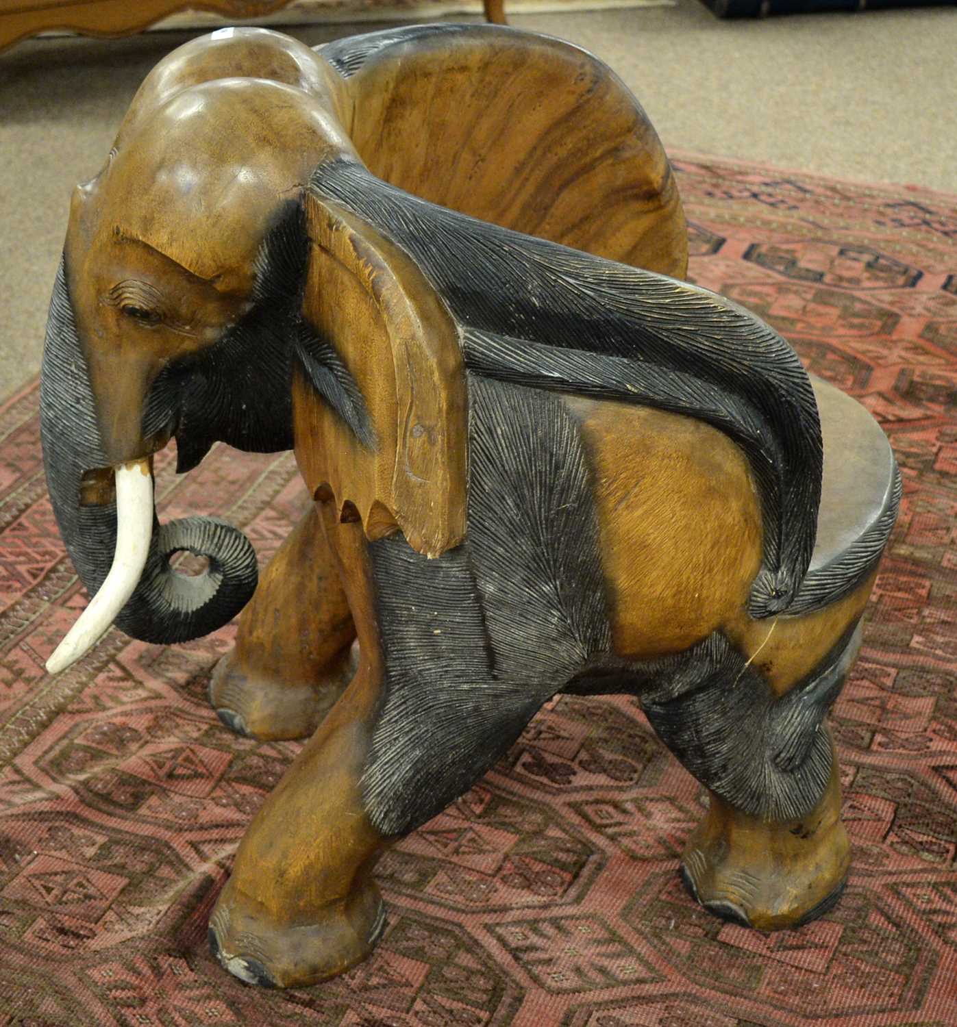 Lot 106 An African carved elephant chair.