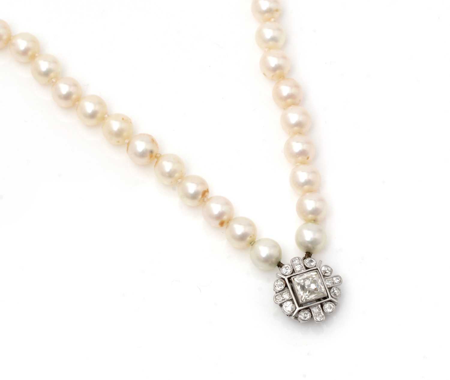 105 - A cultured pearl necklace with diamond clasp,