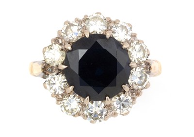 Lot 112 - A sapphire and diamond cluster ring