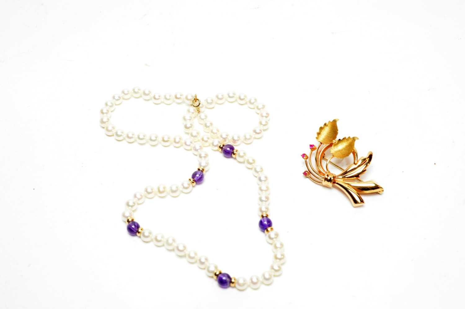 Lot 225 - A yellow-metal flower pattern brooch and an amethyst and pearl necklace
