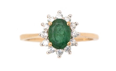 Lot 122 - An emerald and white stone ring