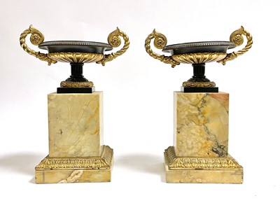 Lot 582 - A pair of late 19th Century Grecian Revival parcel-gilt bronze and marble garniture urns