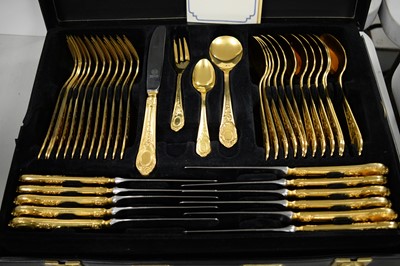 Lot 425 - A canteen of gold-plated German cutlery.