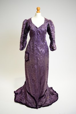 Lot 819 - An 1880s tea-gown of purple damask silk and lace