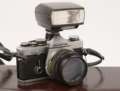 Lot 377 - An Olympus OM-2n SLR film camera with lens and flash gun