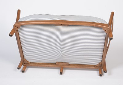 Lot 412 - Attributed to Ercol: a modern beech wood two-seater sofa.