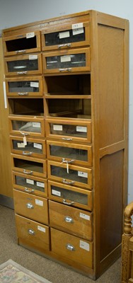 Lot 77 - A vintage light oak haberdashers cabinet
