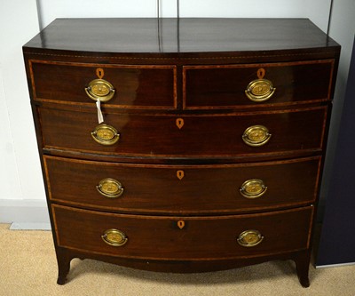 Lot 57 - A George III mahogany and satinwood banded bowfront chest.