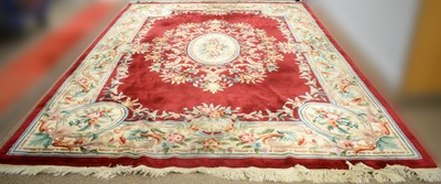 Lot 111 - A Chinese carpet with burgundy ground