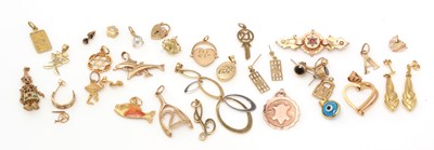 Lot 342 - A selection of 9ct yellow gold and yellow metal charms and pendants